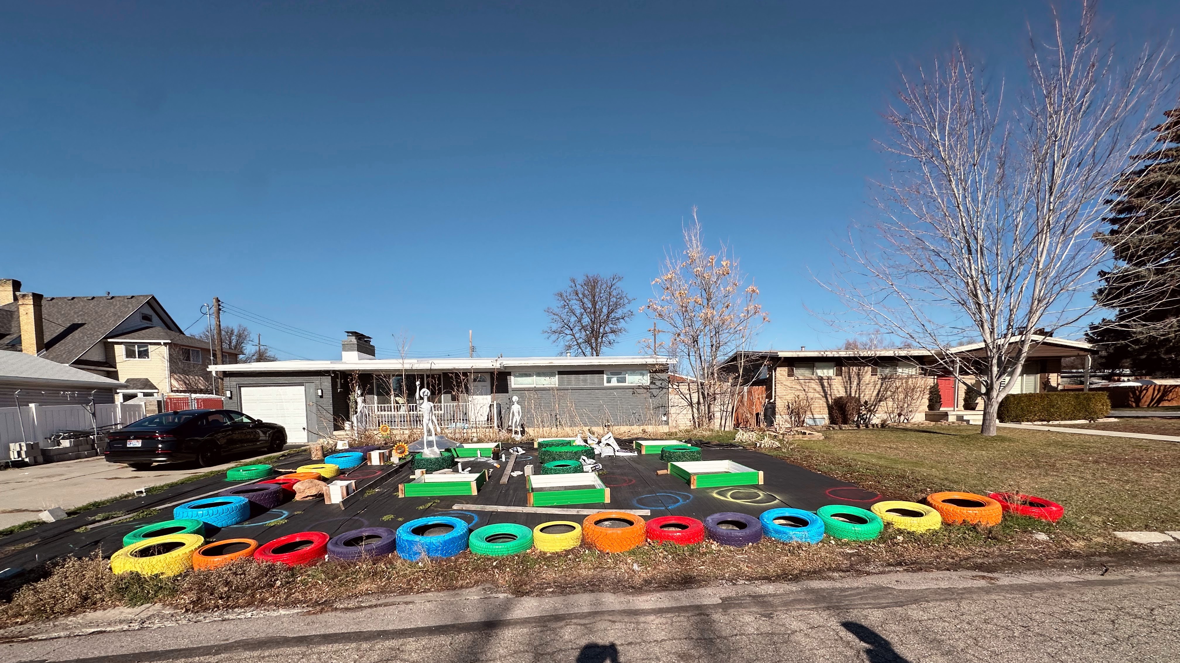a house with rainbow painted tires in front